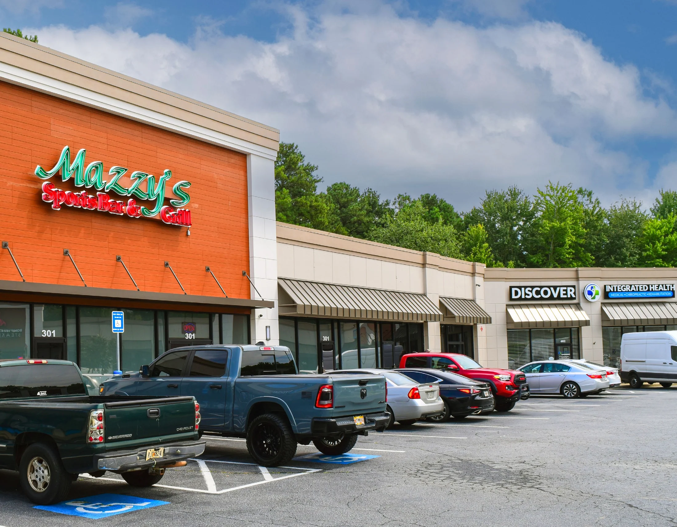Storefront row at Shiloh Crossing with Discover Integrated Health and Mazzy's signage